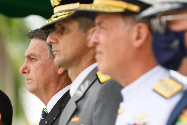 Federal police escort handcuffed Bolsonaro aides past Congress after arrests for alleged coup conspiracy.