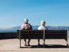 FDA Approves Donanemab Despite 36.8% Brain Swelling Risk A doctor reviewing brain scan images on a monitor while an elderly patient sits nearby in a clinic examining room.