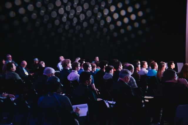 World leaders and delegates gather at a conference table for the AI Seoul Summit 2024, with digital screens displaying AI governance principles.