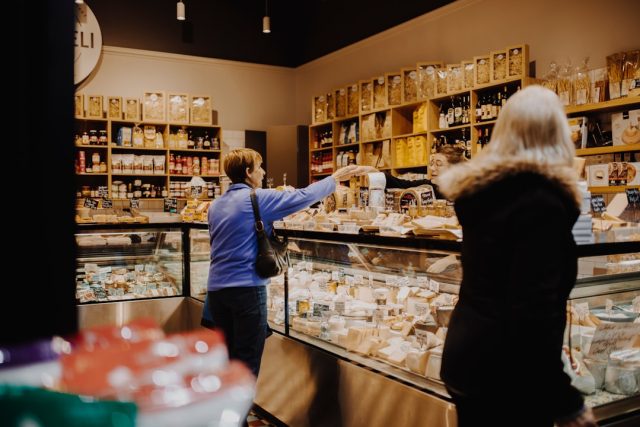 Boar's Head Listeria Outbreak Exposes Gaps in Food Safety Oversight A Boar's Head deli meat display case with a recall notice taped to the glass, highlighting the listeria contamination crisis.