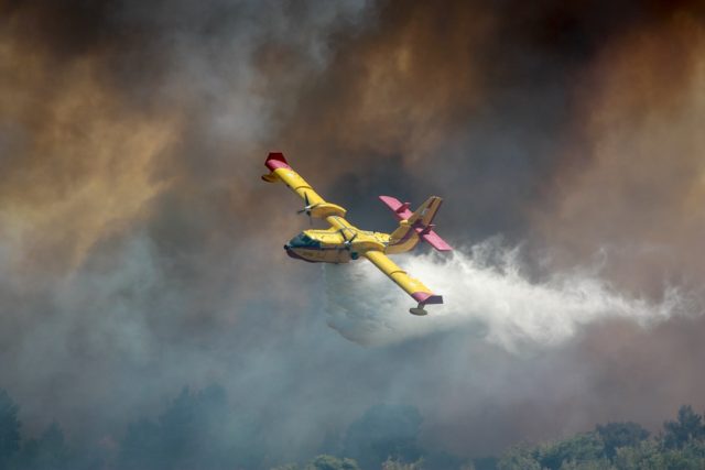 Smoke billows over Lassen Peak as the Park Fire burns through Lassen National Forest near the closed national park.