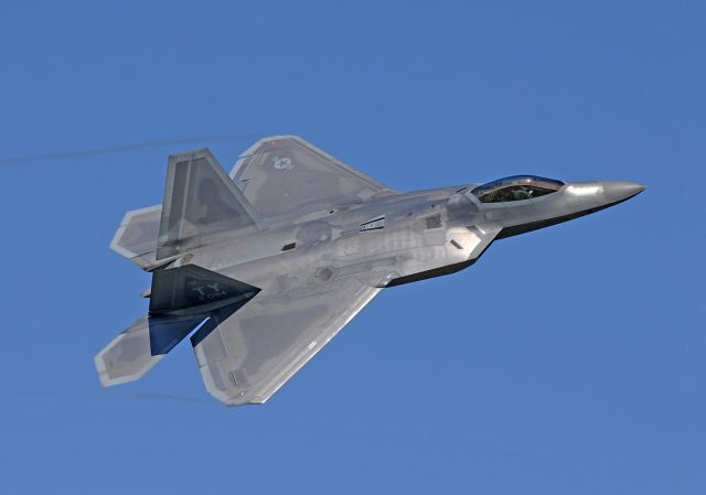 Military aircraft flying over a Middle Eastern landscape during airstrike operations