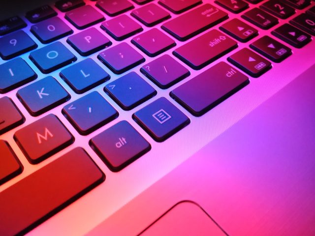 A person typing on a laptop with a ChatGPT interface visible, surrounded by icons representing customer service, content creation, and coding tasks.