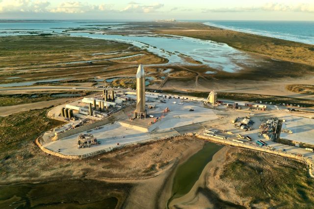 SpaceX's Starship rocket launches from the pad with 33 Raptor engines firing, lifting the massive vehicle into the sky.