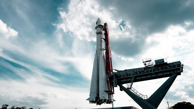 SpaceX Super Heavy booster held by steel Mechazilla arms at the launch tower after a successful catch during flight test 5.