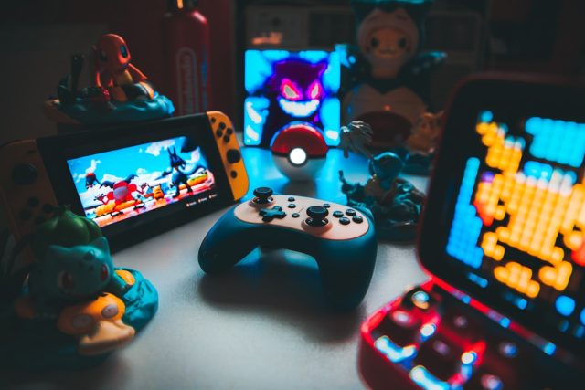 Lenovo Legion Go Ships with Windows 11, Expanding Handheld Gaming Options A person holding a Lenovo Legion Go handheld gaming device, displaying a game launcher interface on its screen.