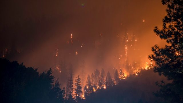 Smoke rising from a wildfire near a village in northeastern Greece as residents flee their homes.