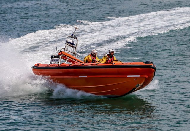 Rescuers search a river in Équateur Province for survivors after a boat carrying passengers and cargo capsized.