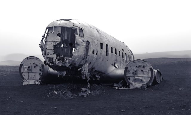 Wreckage of a twin-engine business jet scattered across a wooded hillside near Hot Springs, Virginia, with emergency responders examining the site.