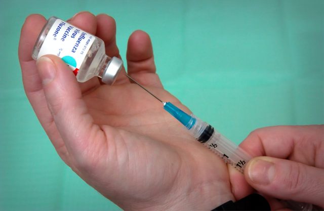 Nurse draws up 4CMenB meningitis vaccine vials in English sexual health clinic ahead of rollout
