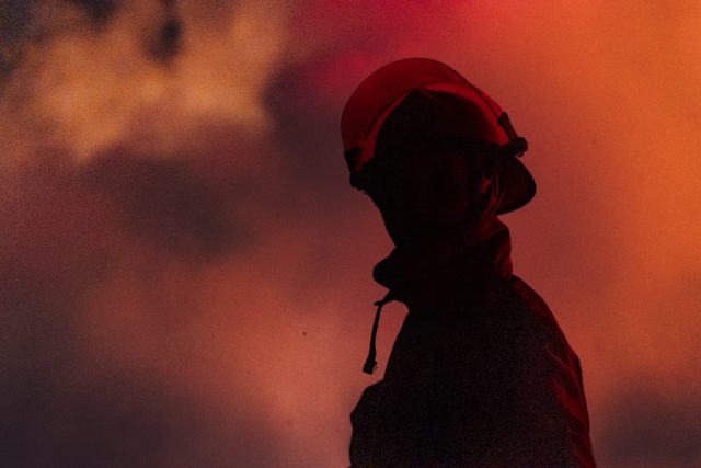 Fire trucks and responders outside a smoke-blackened building beside the elevated Palam metro station on Delhi’s Magenta Line.
