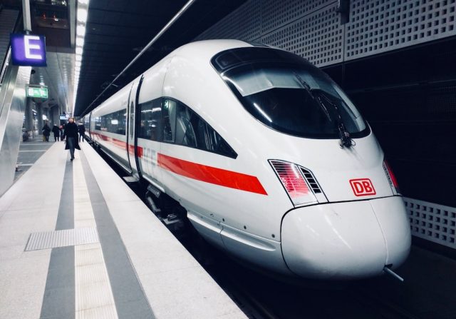 Jakarta-Bandung High-Speed Rail Carries 2.56 Million Passengers in First Six Months A high-speed train speeds past green Indonesian countryside, with passengers boarding at a modern station.