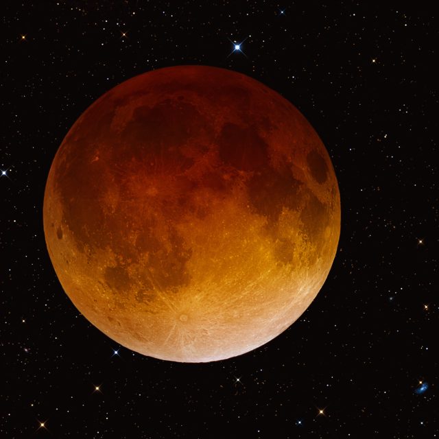 Sky gazers watch the Moon turn a deep reddish hue during a total lunar eclipse visible across the Western Hemisphere.