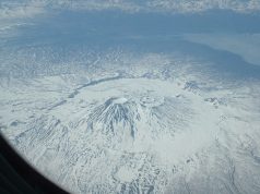 Krasheninnikov Volcano Erupts After 8.8 Quake Aerial view of Krasheninnikov volcano erupting on Russia's Kamchatka Peninsula, with ash plume rising above the snow-capped caldera.