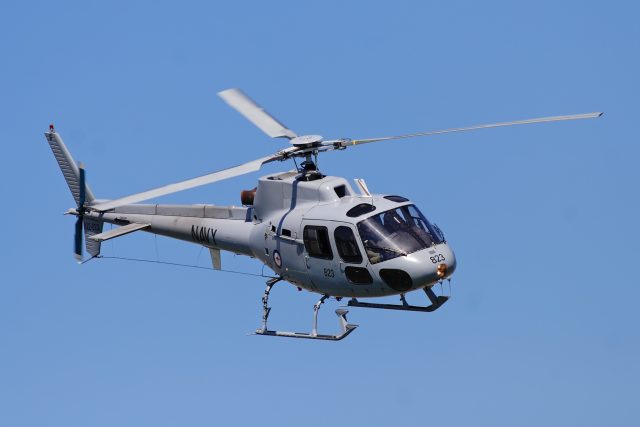 A Eurocopter AS350 Écureuil helicopter flying over a mountainous region in Central Papua, Indonesia.