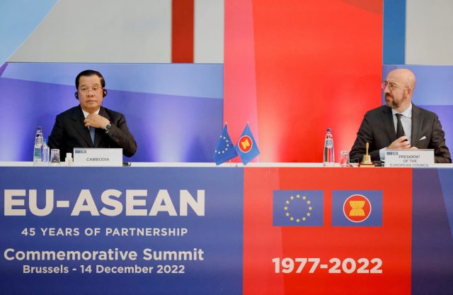 EU and ASEAN officials shaking hands at a signing ceremony for a multi-billion euro investment package.
