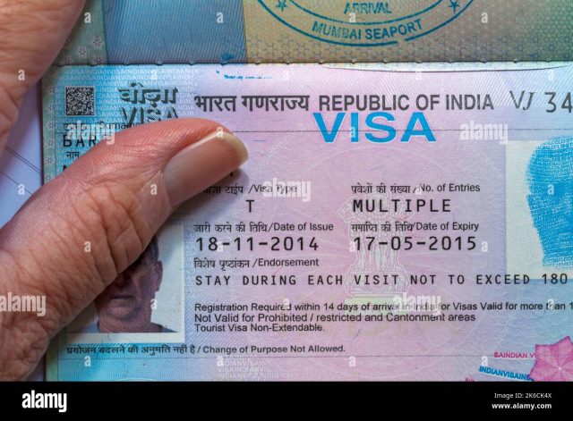 Indian embassy officials review visa applications at a counter in Beijing as new coronavirus restrictions take effect.