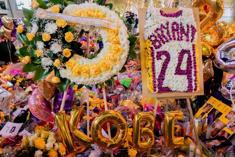 Kobe Bryant Helicopter Crash Memorial Empty Staples Center court lit in purple and gold with Bryant jerseys on every seat