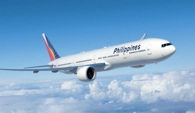 A Philippine Airlines aircraft parked at a terminal with passengers walking near the boarding gate.