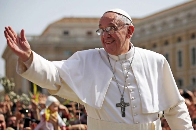 Pope Francis Pope Francis waves from balcony of St Peter’s Basilica in white papal robes under clear sky