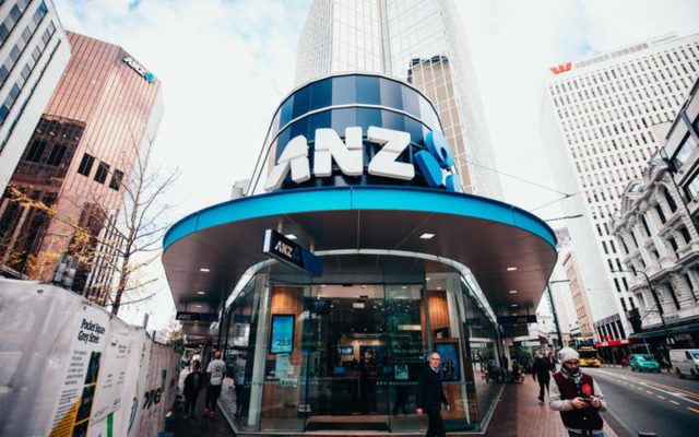 A courtroom in Wellington with investors and legal documents on a table, representing the lawsuit against ANZ Bank.