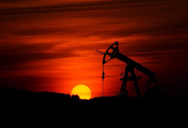 Oil market volatility continues after Soleimani killing and Strait concerns A fuel pump displays rising prices as a driver fills a car, reflecting the oil market volatility after the Soleimani killing.