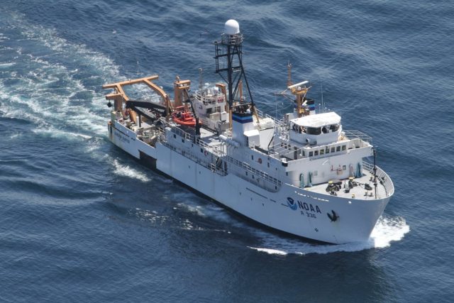 Ocean Infinity autonomous underwater vehicle being deployed from a ship to search the ocean floor for wreckage.