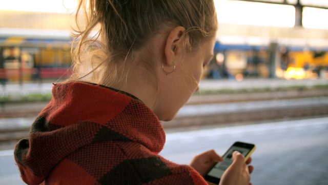 Google Launches Gemini Mobile Apps, Expanding AI Access Beyond Browsers A smartphone screen displays the Gemini app interface with a text input field and a chat conversation below