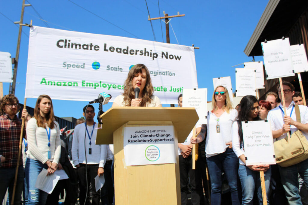 Amazon employees holding signs during a climate strike outside a corporate office