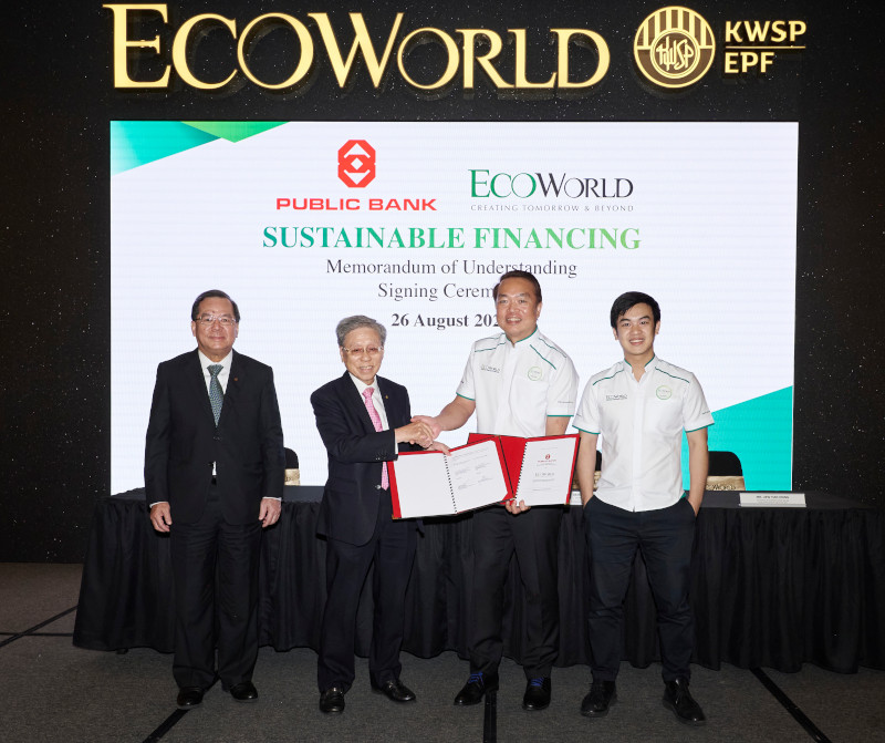 EcoWorld and Public Bank representatives shaking hands at a signing ceremony for a green financing MoU at Eco Grandeur township.